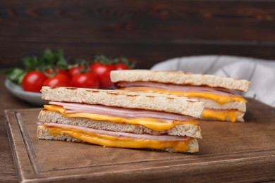 Photo of Delicious grilled sandwiches with ham and cheese on table, closeup
