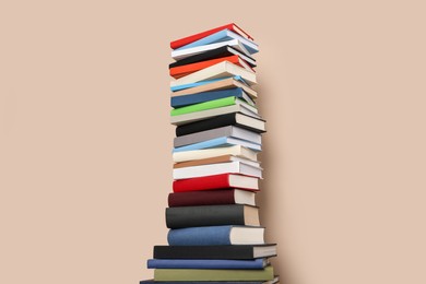 Photo of Stack of hardcover books on beige background
