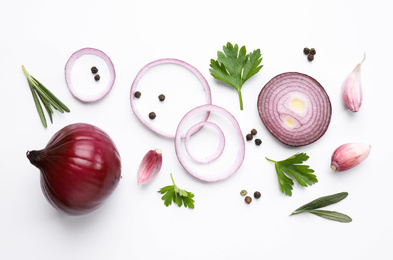 Flat lay composition with cut onion and spices on white background