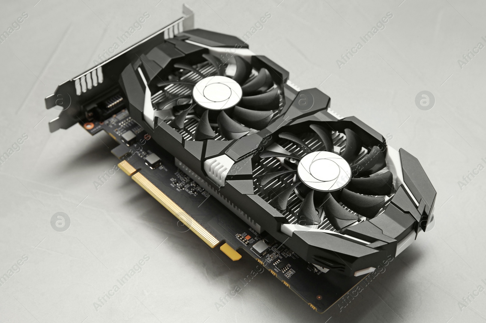 Photo of Computer graphics card on gray textured background, closeup