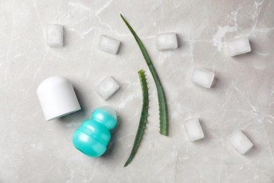 Photo of Flat lay composition with deodorant, aloe and ice cubes on grey background