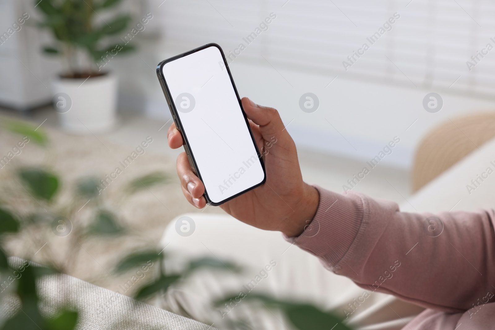 Photo of Man using modern mobile phone indoors, closeup