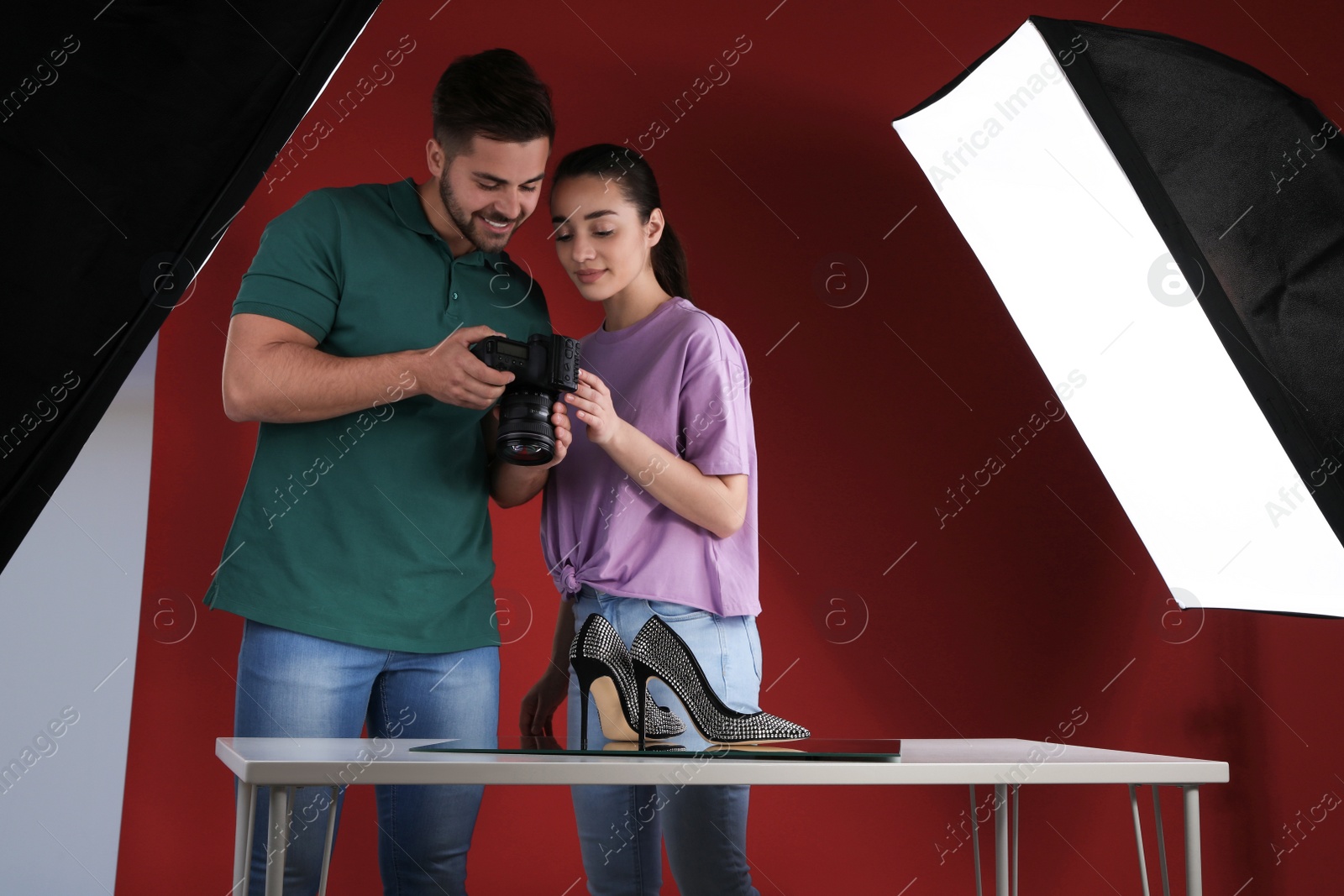 Photo of Professional photographers shooting stylish shoes in studio