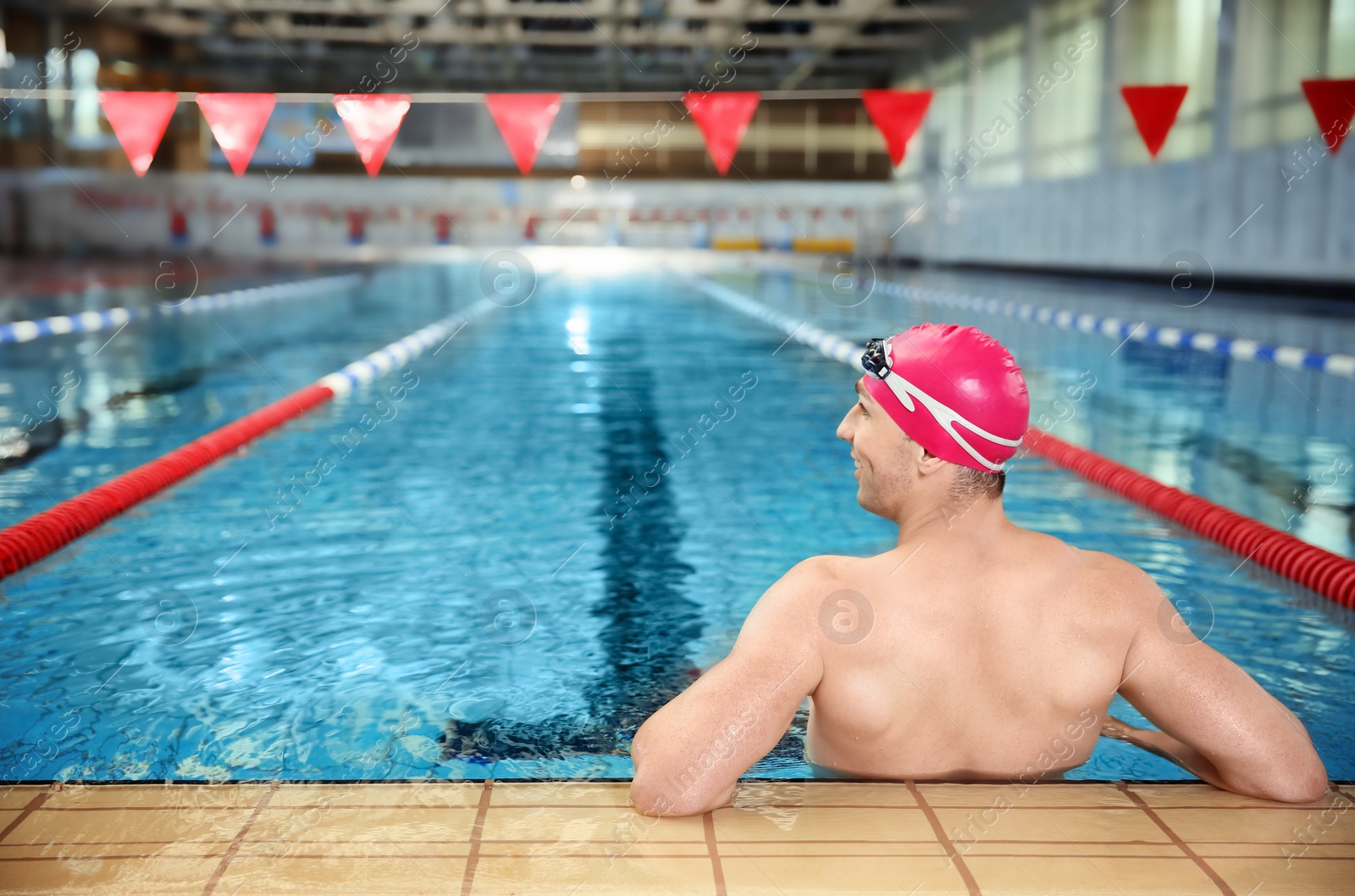 Photo of Young athletic man in swimming pool