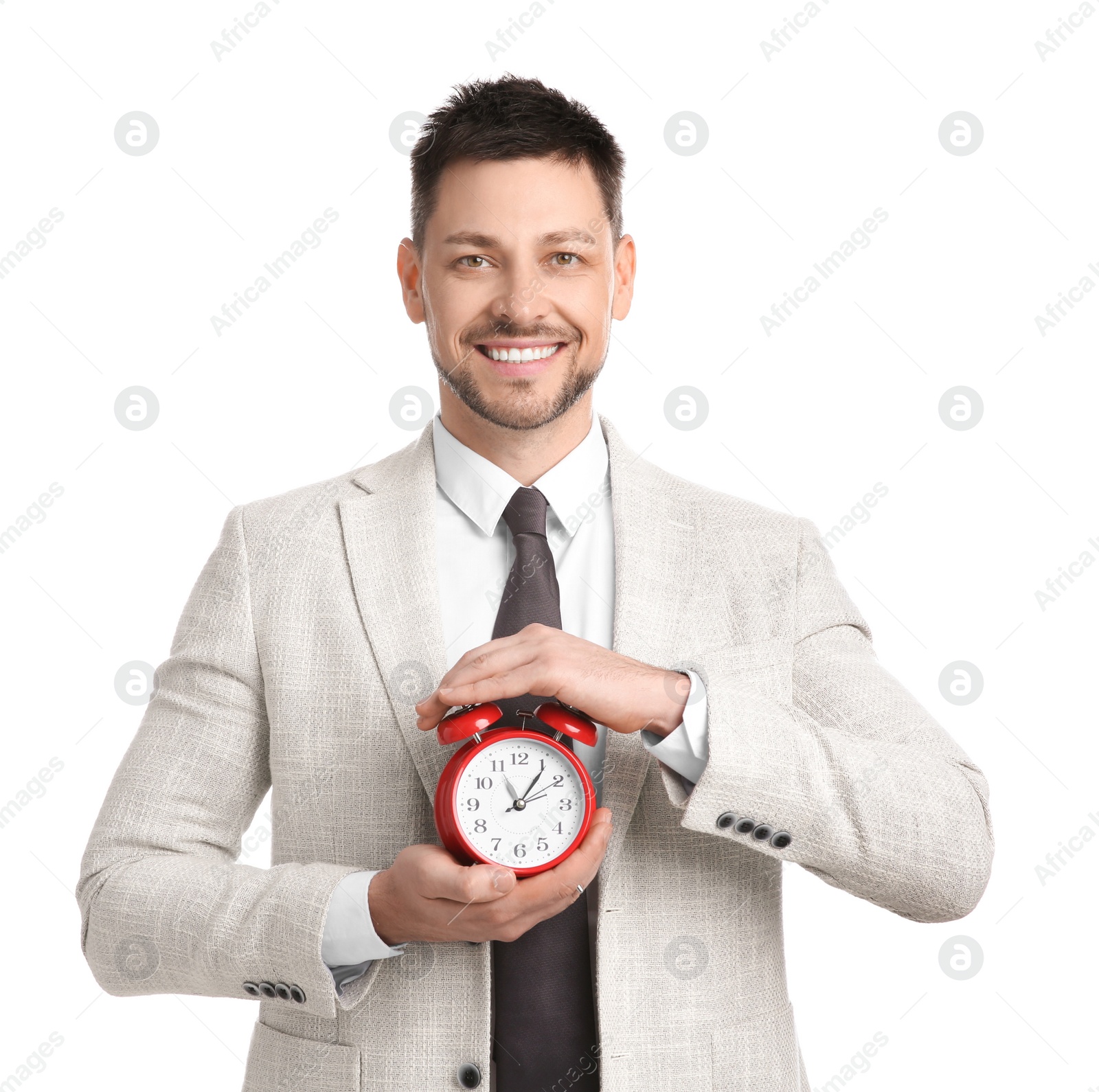 Photo of Happy businessman holding alarm clock on white background. Time management