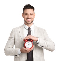 Happy businessman holding alarm clock on white background. Time management