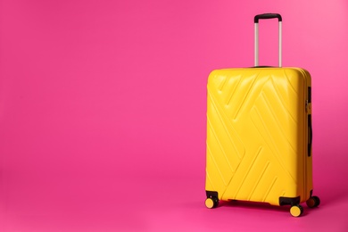 Stylish suitcase on color background. Space for text