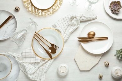 Festive Easter table setting on wooden background, top view