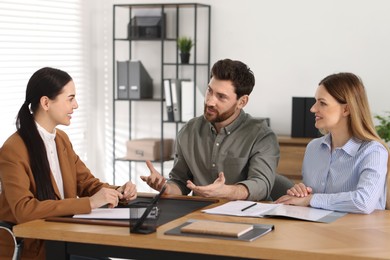 Photo of Couple having meeting with lawyer in office