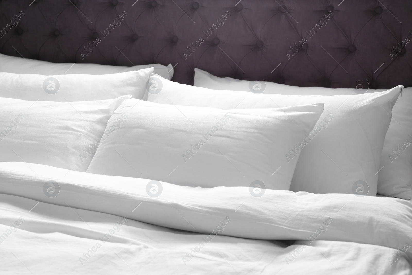 Photo of Modern bed with soft pillows in room