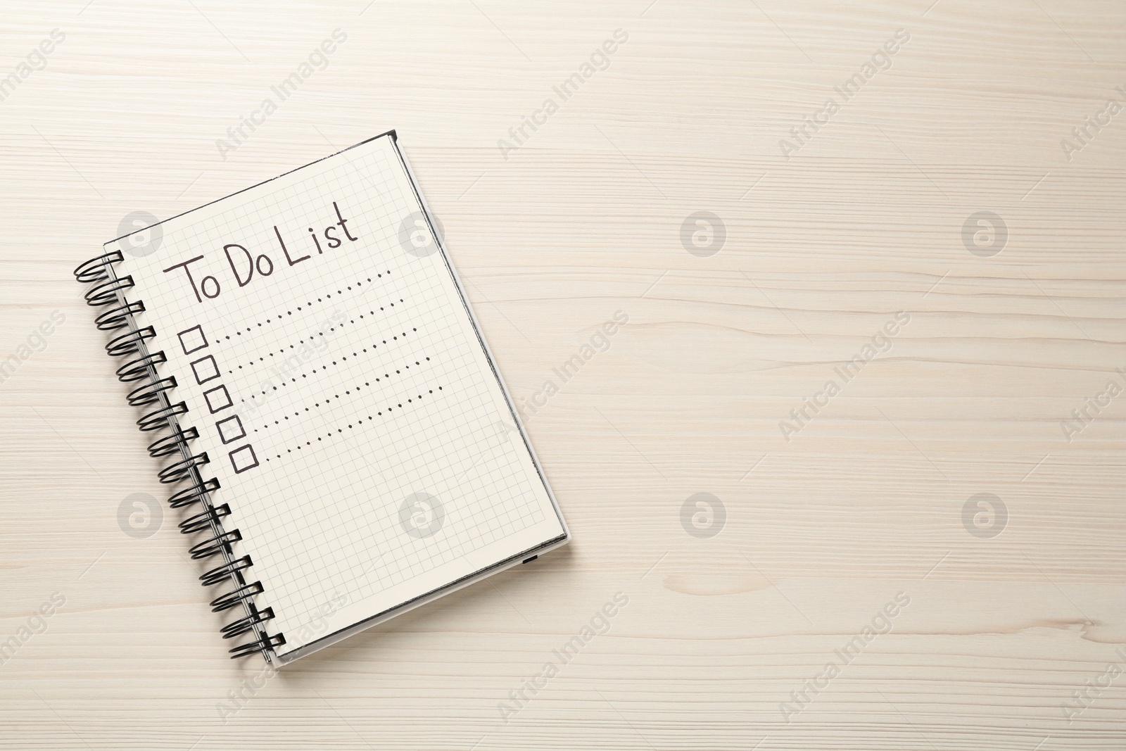 Photo of Notepad with unfilled To Do list and checkboxes on wooden table, top view. Space for text