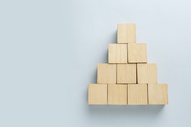 Blank wooden cubes on light background, flat lay. Space for text