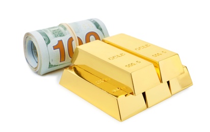 Shiny gold bars and dollar bills on white background