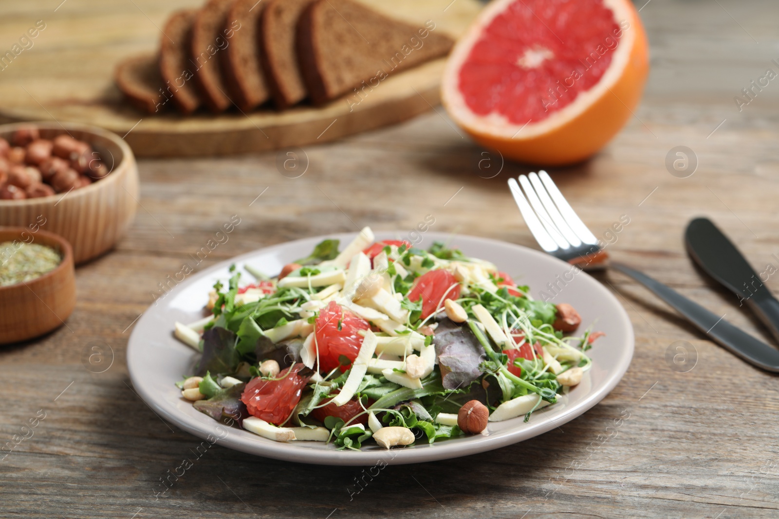 Photo of Delicious carrot salad served on wooden table