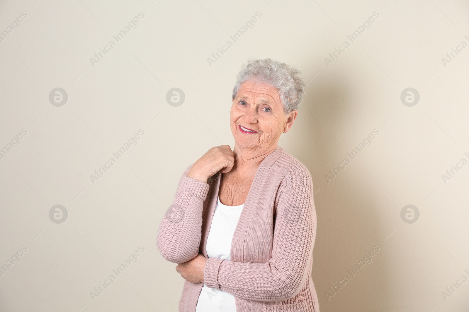 Photo of Portrait of grandmother in stylish clothes on light background