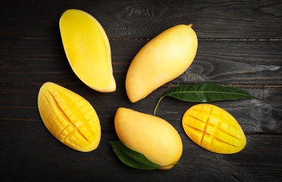 Photo of Flat lay composition with mango on wooden background
