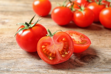 Photo of Fresh organic cherry tomatoes on wooden background