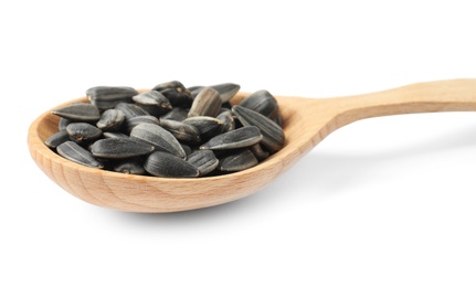 Raw organic sunflower seeds in wooden spoon isolated on white