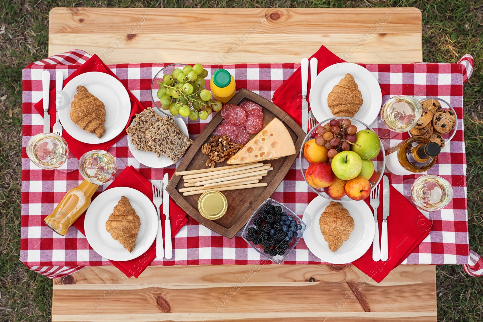 Photo of Picnic table with different tasty snacks, top view