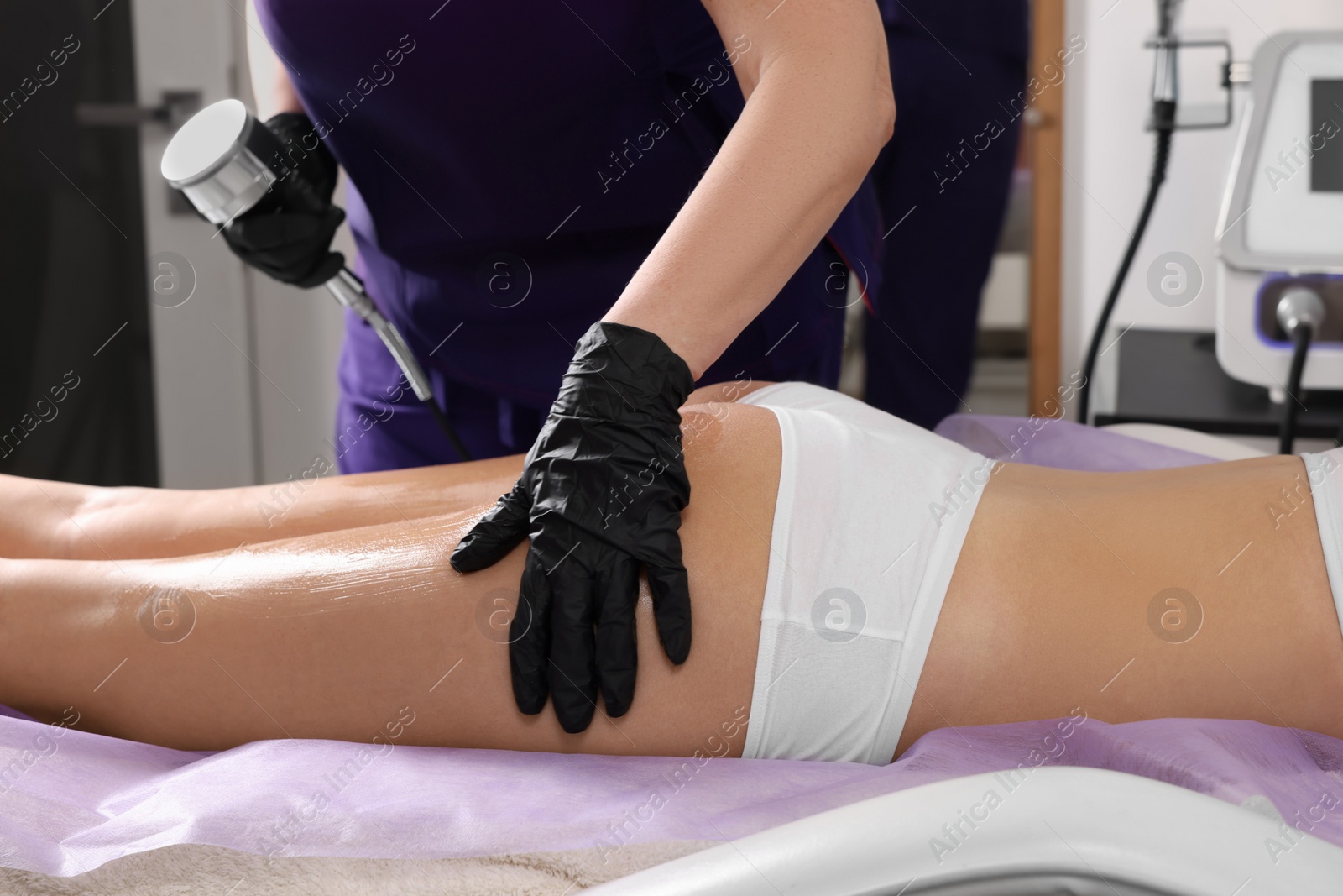 Photo of Woman undergoing radio frequency lifting procedure in beauty salon, closeup