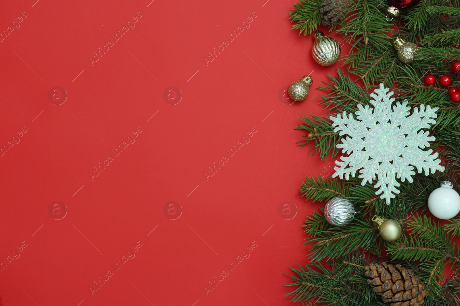 Photo of Flat lay composition with Christmas decor on red background, space for text