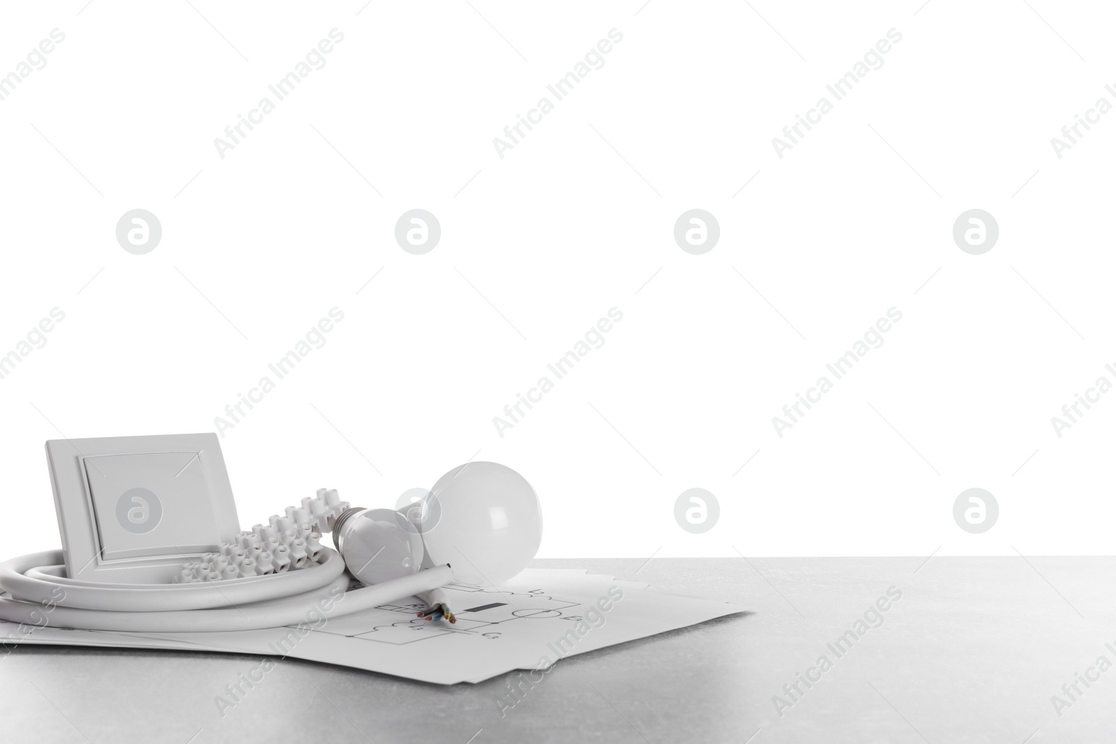 Photo of Set of electrician's tools and accessories on grey table against white background