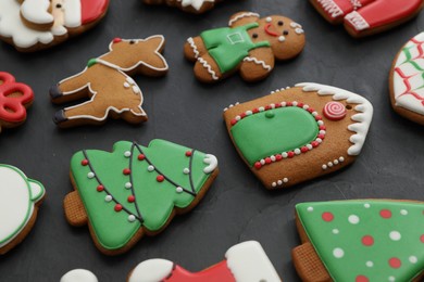Photo of Many different delicious Christmas cookies on black table