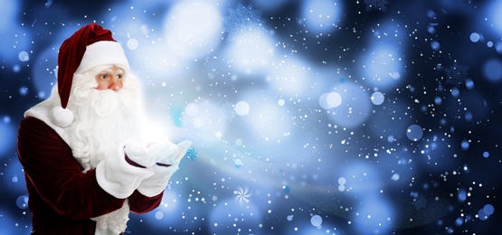 Image of Santa Claus blowing magic snow around, bokeh effect. Space for text