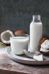 Photo of Composition with coconut milk on wooden table