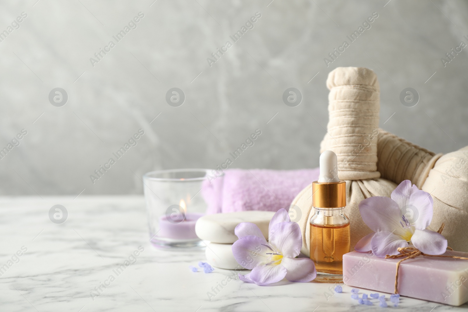 Photo of Spa composition with skin care products on white marble table, space for text