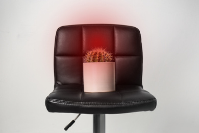 Image of Hemorrhoid concept. Chair with cactus on white background