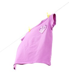 Photo of One violet t-shirt drying on washing line isolated on white