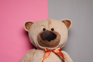 Photo of Cute teddy bear on color background, top view