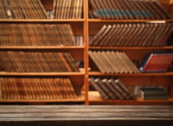 Empty wooden table in library. Space for design 