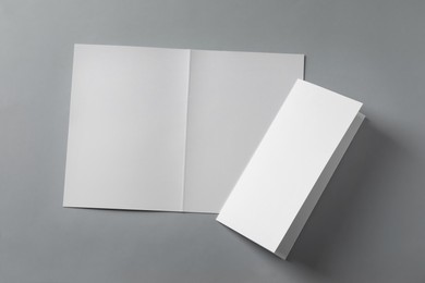 Photo of Blank paper sheets for brochure on light grey background, flat lay