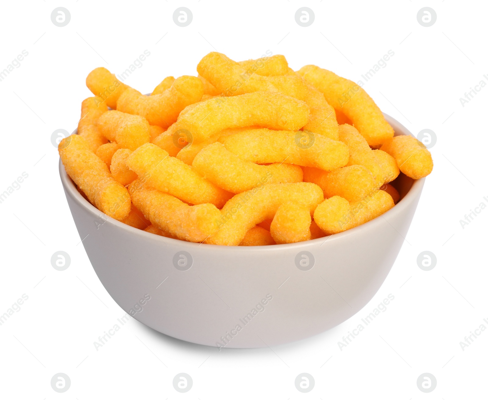 Photo of Many tasty cheesy corn puffs in bowl isolated on white