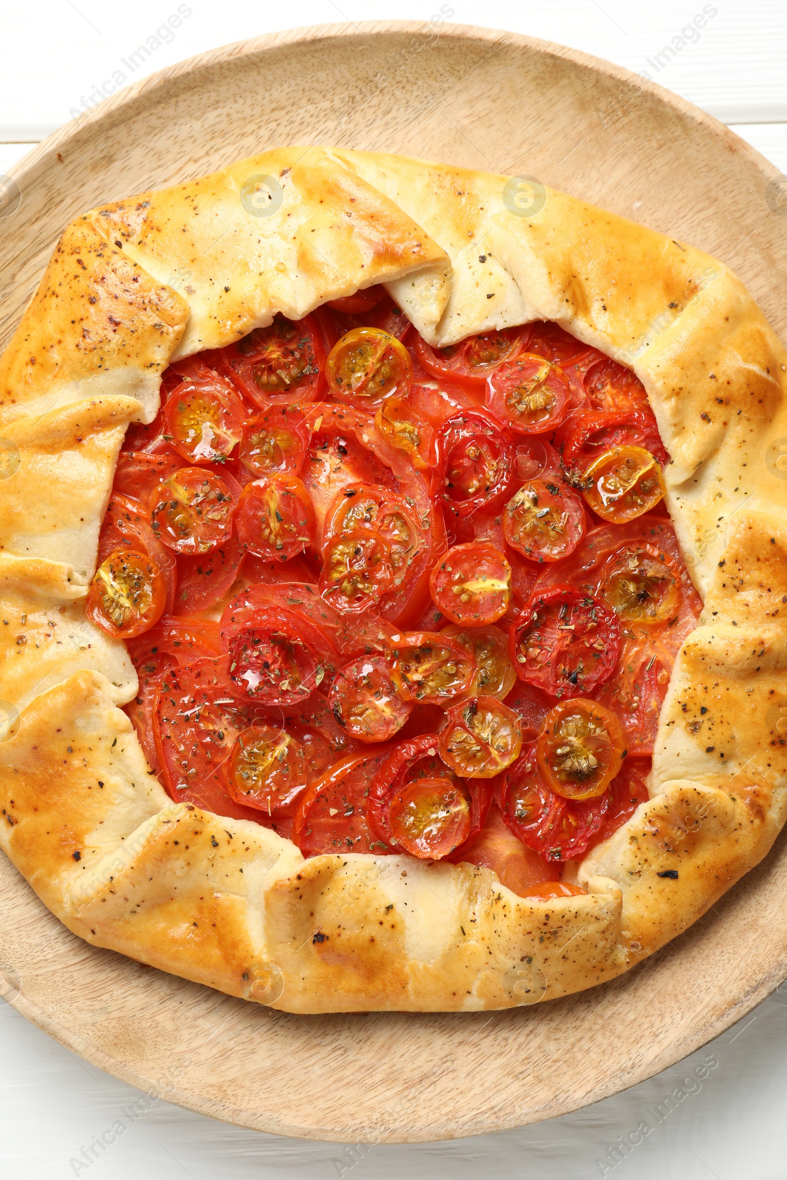 Photo of Tasty tomato galette (Caprese galette) on white wooden table, top view