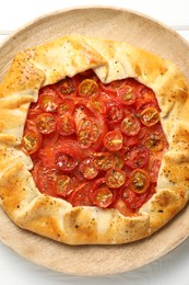 Tasty tomato galette (Caprese galette) on white wooden table, top view