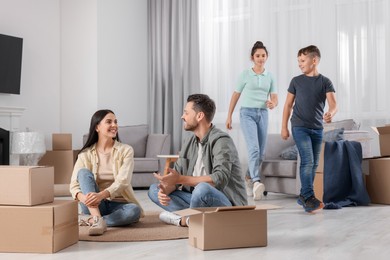 Photo of Happy family spending time in new apartment. Moving day