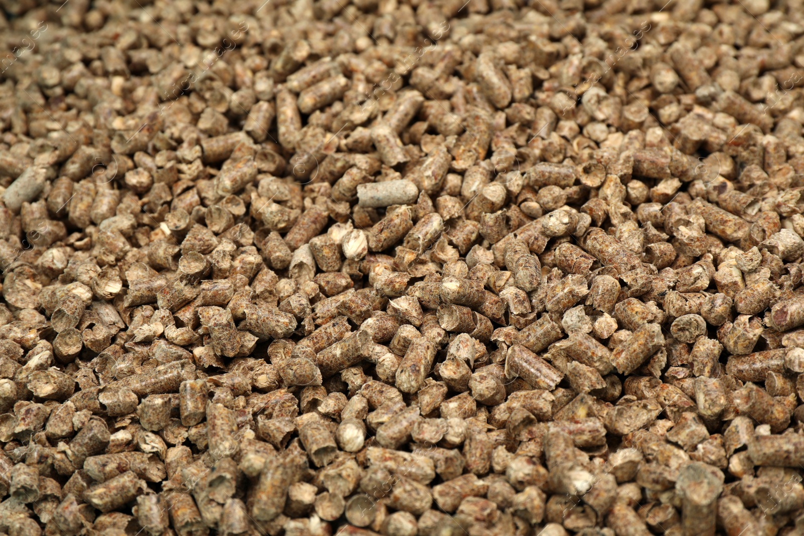 Photo of Wood pellet cat litter as background, closeup