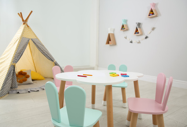 Cute children's room interior with teepee tent and little table