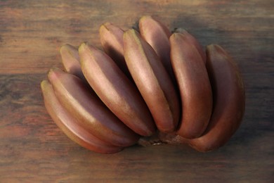 Photo of Tasty purple bananas on wooden table, closeup