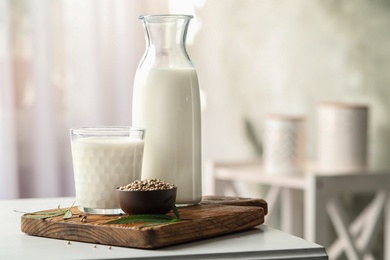 Photo of Composition with hemp milk on white table indoors