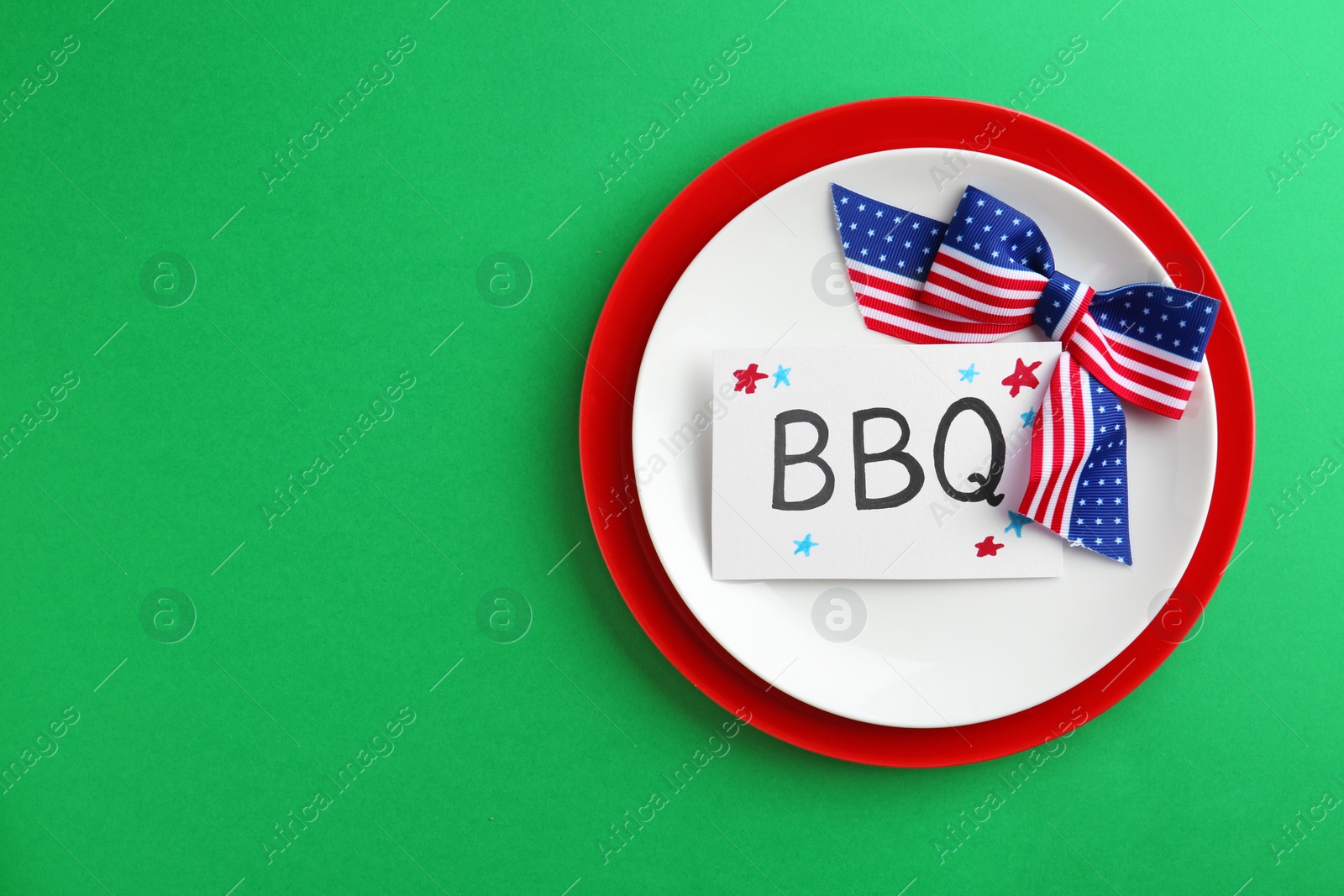 Photo of Set of dishware on color background, top view with space for text. USA Independence Day