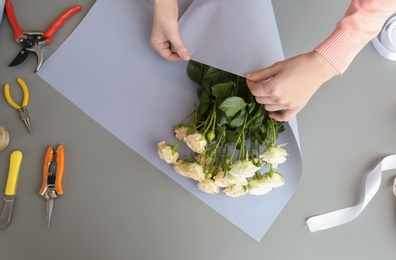 Female florist creating bouquet at workplace