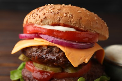 Photo of Tasty cheeseburger with patties, onion and tomato, closeup