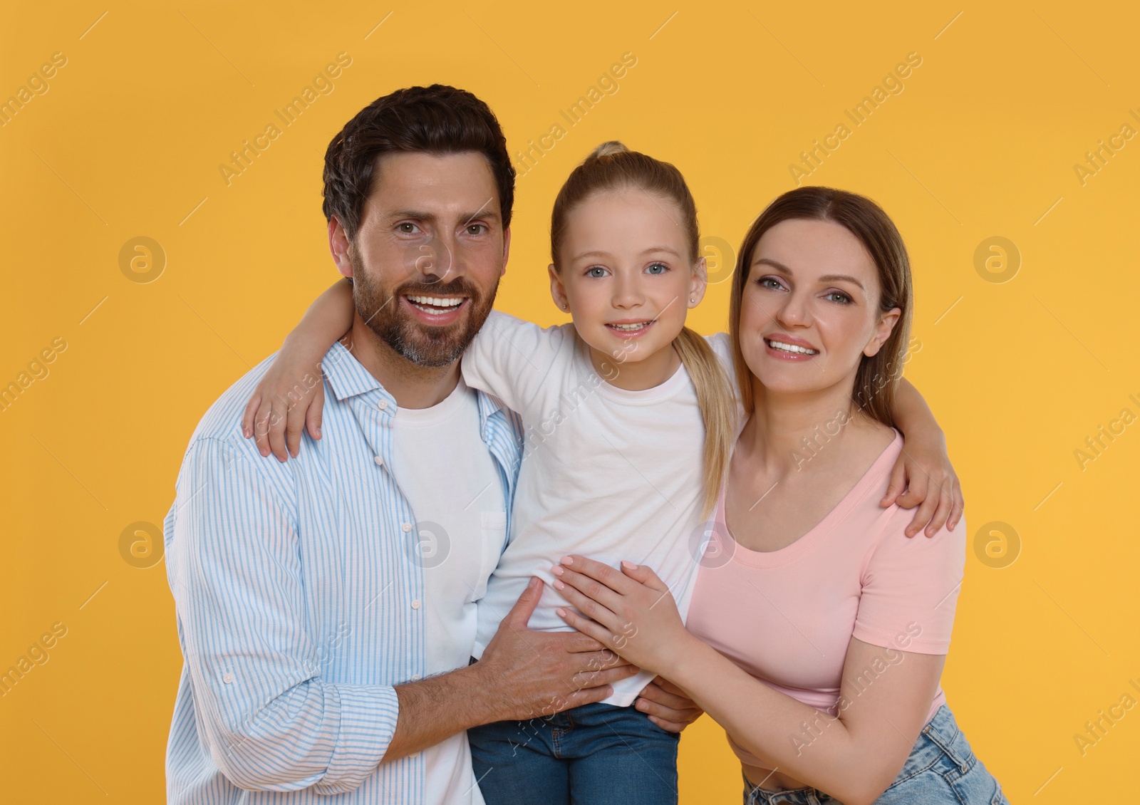 Photo of Portrait of happy family on orange background