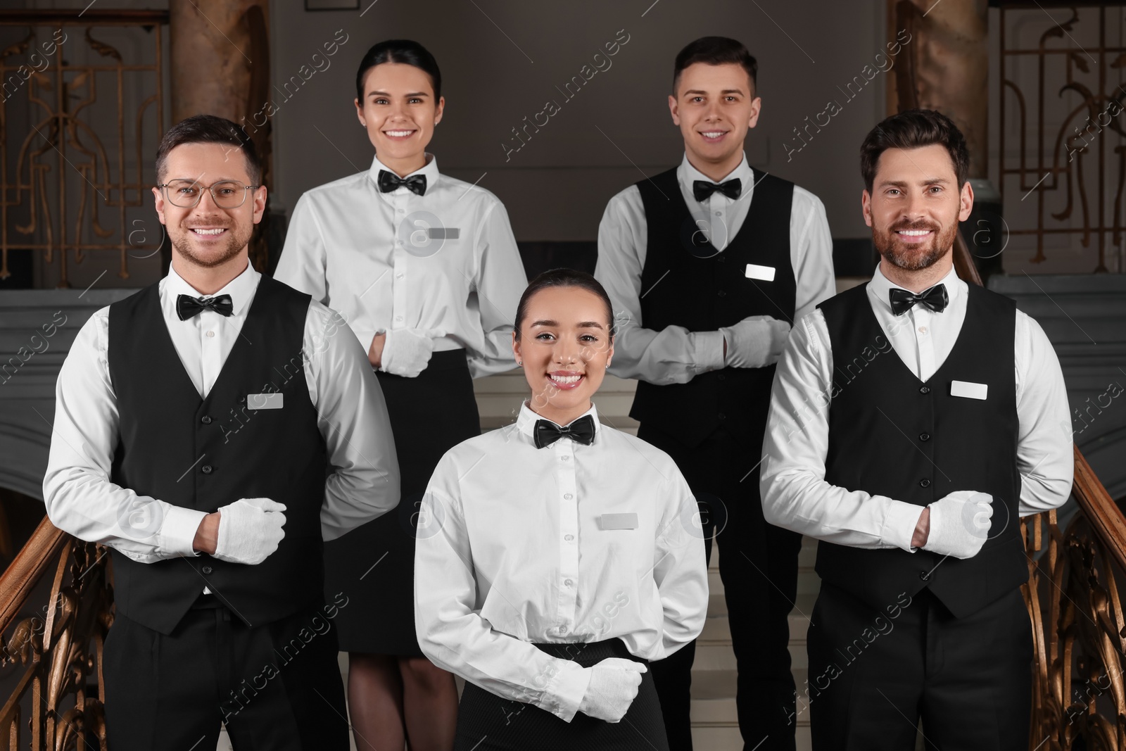 Photo of Group of trainees wearing formal clothes in hotel. Professional butler courses