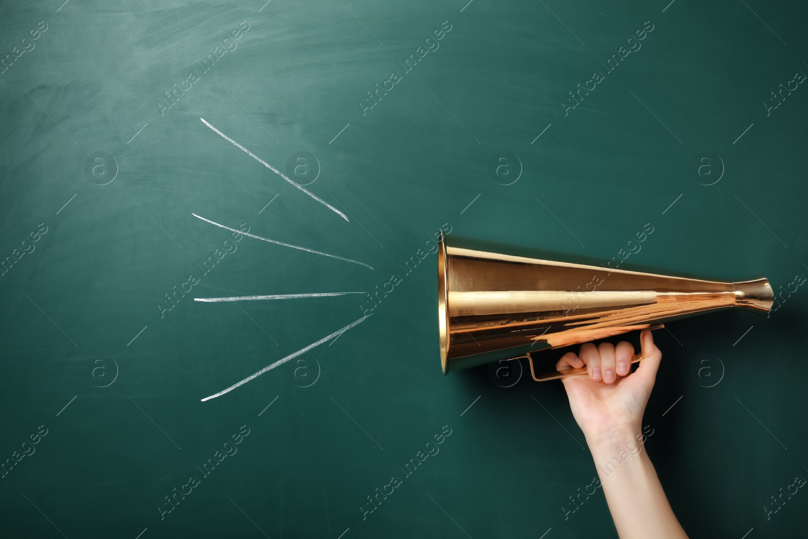 Photo of Woman holding retro megaphone near chalkboard