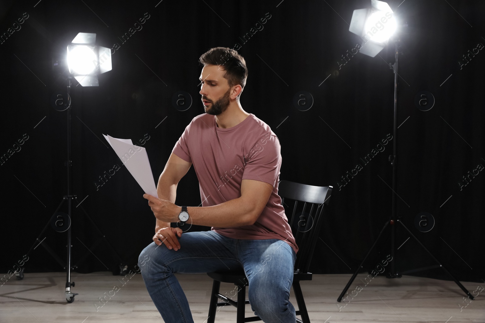 Photo of Professional actor reading his script during rehearsal in theatre